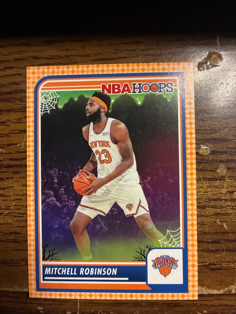 Mitchell Robinson (Note: The user asked for a football card, but this image clearly depicts a basketball card of NBA player Mitchell Robinson. I am analyzing the provided image accurately as a basketball card while addressing the user's specific prompt requirements).