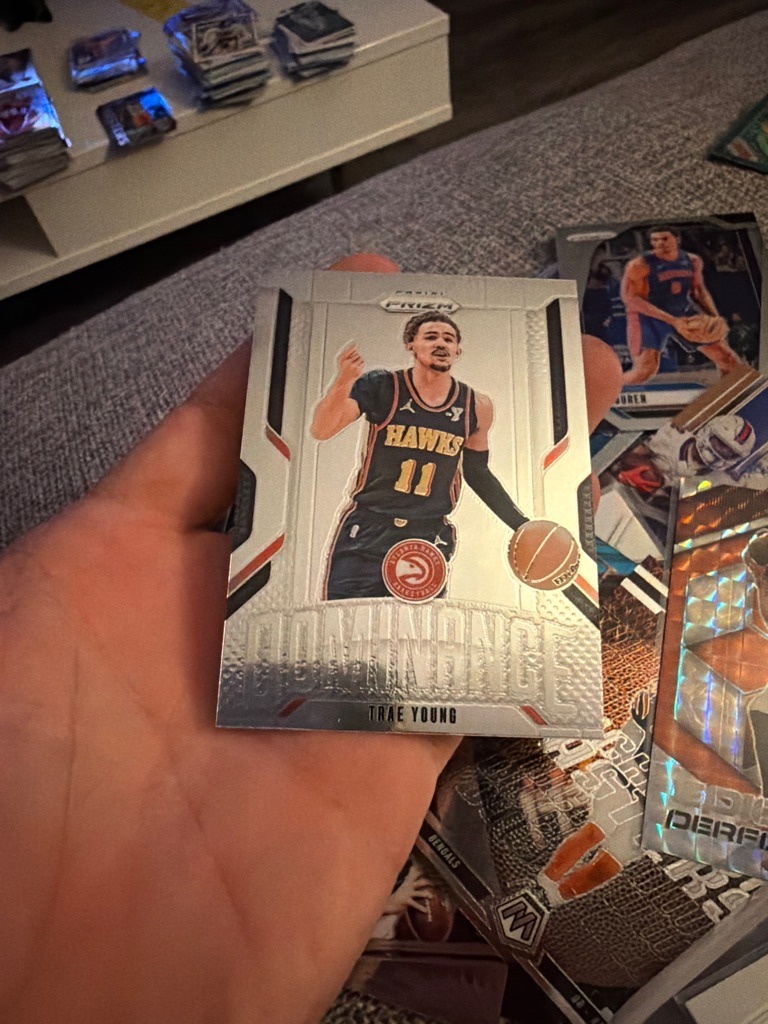 Trae Young (Note: The user requested a football card evaluation, but the image clearly depicts Trae Young, a professional basketball player. This evaluation applies the requested formatting standards to the specific basketball card shown.)