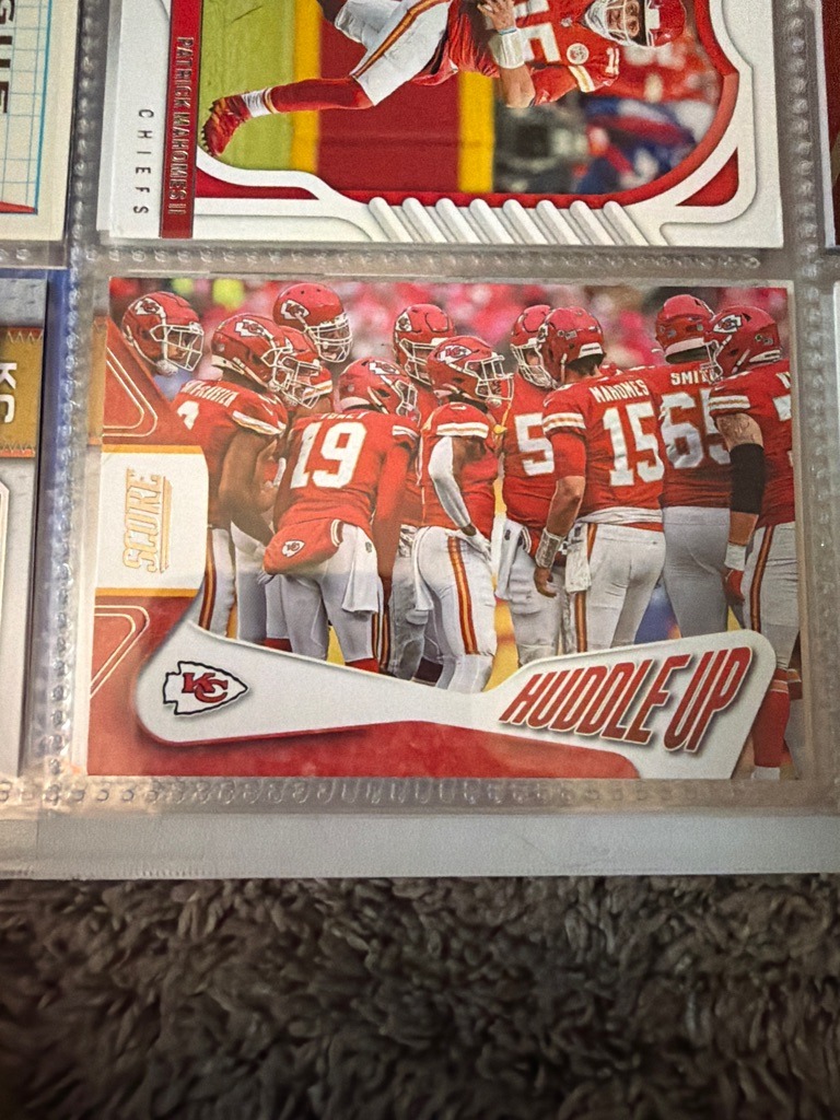 Patrick Mahomes (Featured prominently in the huddle alongside teammates)